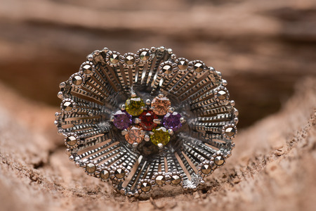 Silver handcrafted ring against a wooden backgroundの写真素材