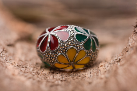 Silver handcrafted ring against a wooden backgroundの写真素材