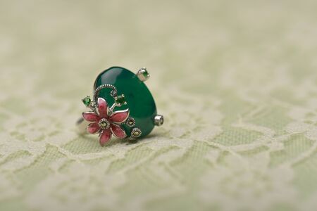Green jade and colorful small stones  on a silver ringの写真素材