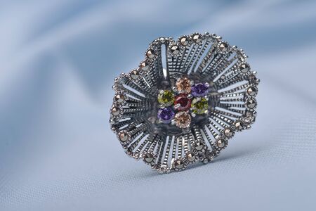 Colorful  zirconium silver  ring  on textile surfaceの写真素材