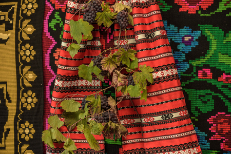 Ripe grapes against  colorful handmade vintage background