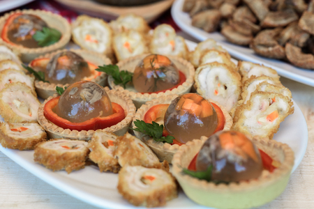 Appetizers with pork jelly and pastry on white plate close upの写真素材
