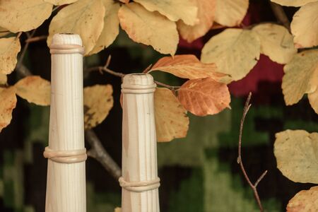 Handmade wooden items against autumn leaves and vintage itemsの写真素材