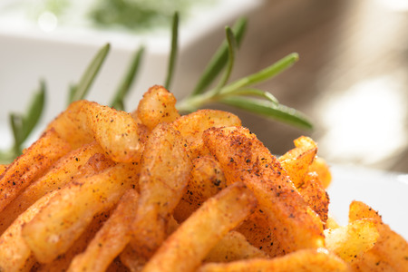 French fries and rosemary close up against blury backgroundの写真素材