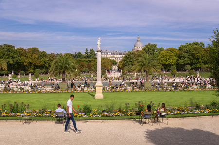 Paris, France 08 04 2023: Hot summer afternoon in Jardin du Luxembourg garden with tourists having rest and enjoying nice weather beside the Les Voiliers du Luxembourg pondのeditorial素材