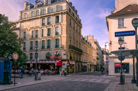 Paris, France 08 04 2023: Summer evening view of Rue Bonaparte and Rue Guillaume Apollinaire crossing with patrons sitting at the tables of outdoor patio of Le Bonaparte restaurantのeditorial素材