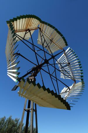 Old fashioned windmill on blue sky
