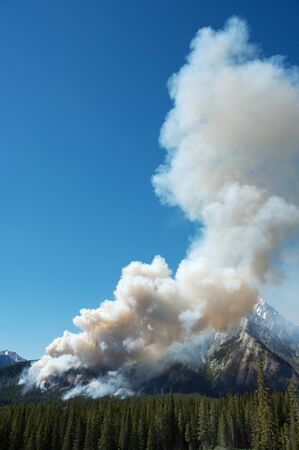 Large forest fire burning in the Rocky Mountainsの写真素材