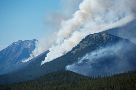 Large forest fire burning in the Rocky Mountainsの写真素材