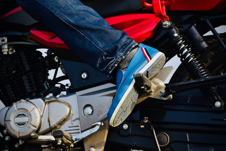 Bikers leg wearing leather shoes stock photographの写真素材