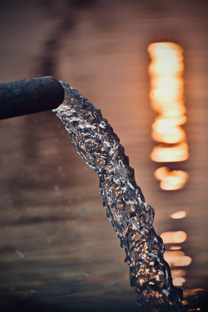 Unique waterfalls from a pipe background photographの写真素材