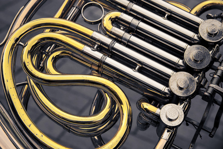 part of the golden and silver metal retro-styled trumpetの写真素材