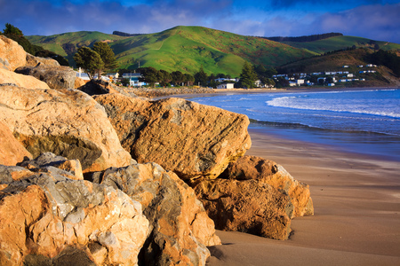 sea and green hills landscape, location - Castlepoint, North Island, New Zealandの写真素材