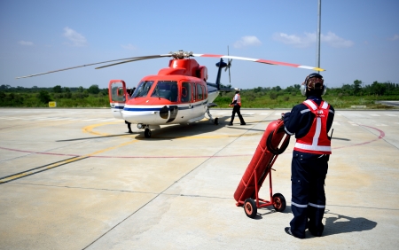 fireman is guarding for helicopter before start up engine.の写真素材