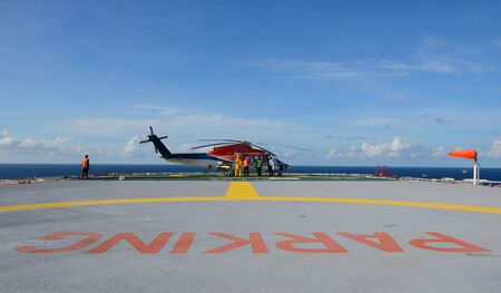 The helicopter refueling on oil rigの写真素材
