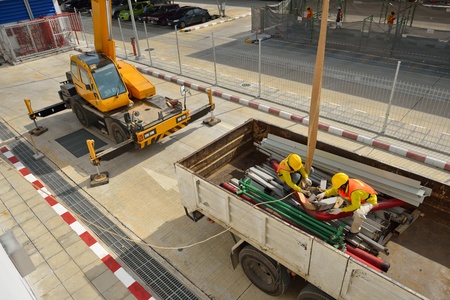 Group of the workers are working on truck 