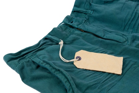 old paper label with string tied with trousers isolated on the white background の写真素材