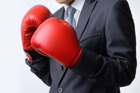 businessman with red boxing glove ready to fight with problem, business conceptの写真素材