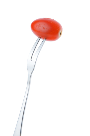 cherry plum tomato on fork isolated on white background,Healthy eating conceptの写真素材