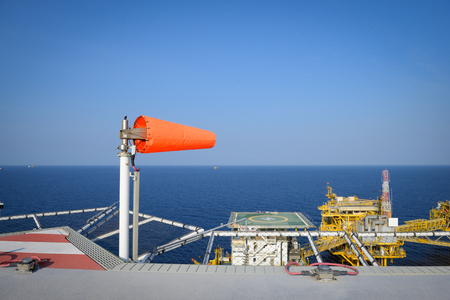 The wind sock is set on the oil rig to showing wind direction for helicopter landing .の写真素材
