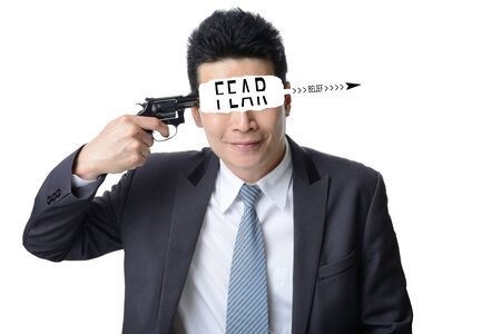 businessman use gun shoot word FEAR in his head isolated on white background ,Motivation conceptの写真素材