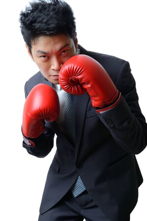 businessman with red boxing glove ready to fight with work, business conceptの写真素材