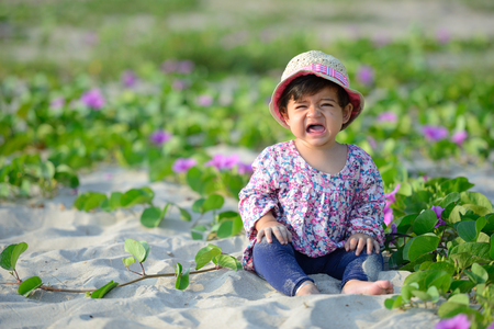 Portrait of crying sad baby girl is on playgroundの写真素材