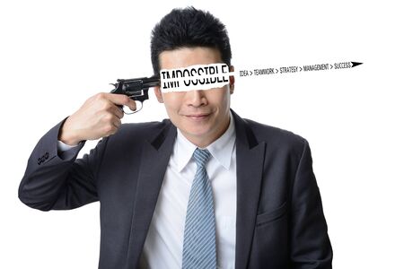 businessman use gun shoot word impossible in his head isolated on white background ,Motivation conceptの写真素材