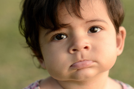cute adorable beautiful face of mixed race baby with innocent expressionの写真素材