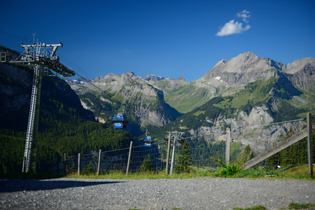 KANDERSTEG, SWITZERLAND - AUGUST 27, 2016: The  cabel cars leading to a mountain for continue walking to Oeschinensee lake in summer.のeditorial素材