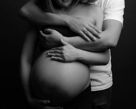 man hug on pregnant woman belly, family conceptの写真素材
