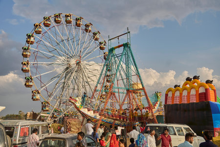 Sikar, India ; 04-13-2023 : A giant ferris wheel and a boat swing in a fairのeditorial素材