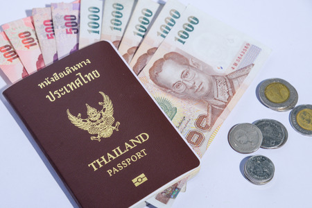 Thailand passport with isolated white background baht banknotes and coinsの写真素材