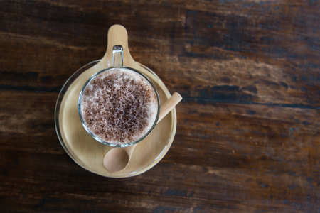 Close up Milk Cocoa smoothie in glass on wood table.の写真素材