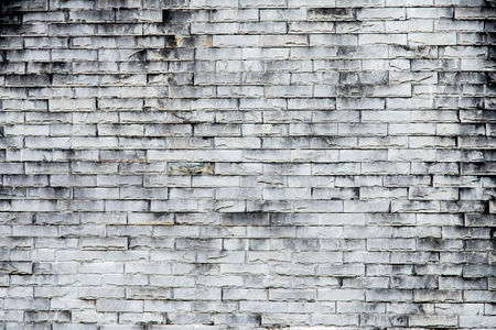 old  gray brick wall texture background.Rough brick wall.Background of old vintage dirty brick wall with peeling plaster, textureの写真素材