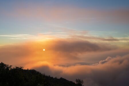 Scenic view sunrise with fog and cloud in mountain valley landscape, misty morning sunrise at chiang dao mountain peak in chiangmai province north of thailandの写真素材