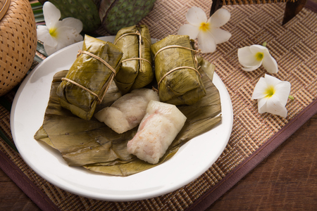 Bananas with Sticky Rice - Khao Tom Mat.Khao tom or khao tom mat is a Laotian and Thai dessert of seasoned steamed sticky rice wrapped in banana leavesの写真素材