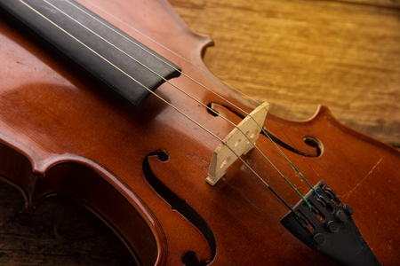 violin in vintage style on wood backgroundの写真素材