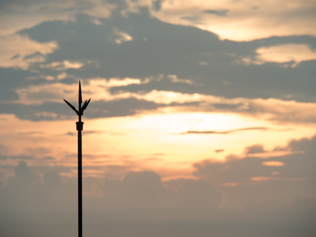 The lightning rod on the roof-tile taken with sunsetの写真素材