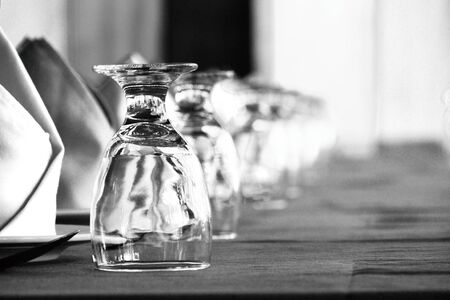 Many glasses of different wine in a row on a table.Rows of empty wine glasses on the showcaseの写真素材