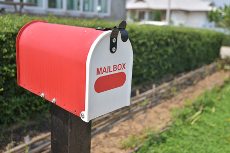 Home office red Metal Mailbox in garden.の写真素材