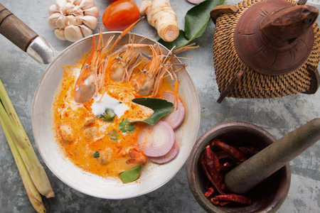 Tom Yum Goong Spicy Sour Soup on wooden table top view, famous Thai food cuisine calling Tom Yum Kungの写真素材