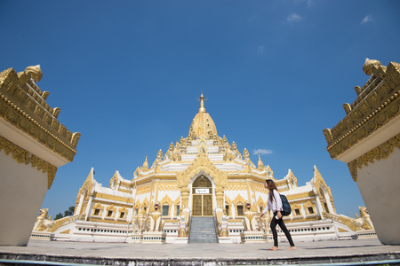 15 December 2016 Female tourist walking at Swe Taw Myat, Buddha Tooth Relic Pagoda a famous and beautiful buddhist temple in yangon , myanmarのeditorial素材