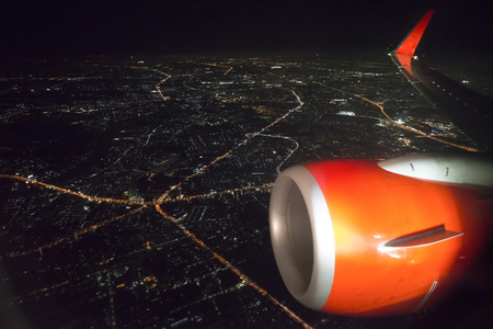 airplane window aerial night view cityscape of Bangkok thailand