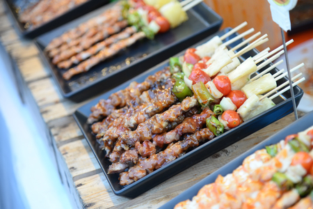 Steak barbecues cooking grilling in street market in thailand,Barbecue grill with various kinds of meat, Soft focusの写真素材