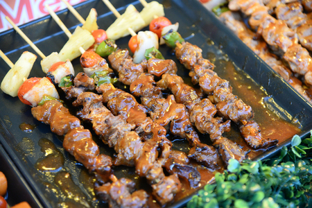 Steak barbecues cooking grilling in street market in thailand,Barbecue grill with various kinds of meat, Soft focusの写真素材