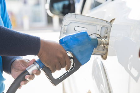Filling gas at the station. Refill oil, gasoline, diesel vehicle.Hand refilling the car with fuel.の写真素材
