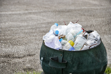 Recyclable garbage bin with uesed plastic and glass bottles.environmental pollution and recycling concept.の写真素材