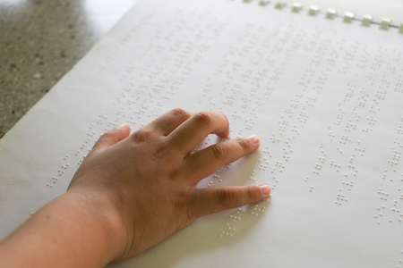 Braille is the font for the blind, invented by Louis Braille. The French blind teacher is a small convex dot in a six-point box, which is arranged alternately into code. Fine letters or mathematical symbols, science, music notes, etc. Writing using a slate and a stylus. Printing using a printer called a Braillerの写真素材