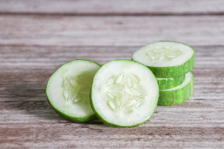 Chopped cucumber.Fresh cucumbers on wooden table.の写真素材